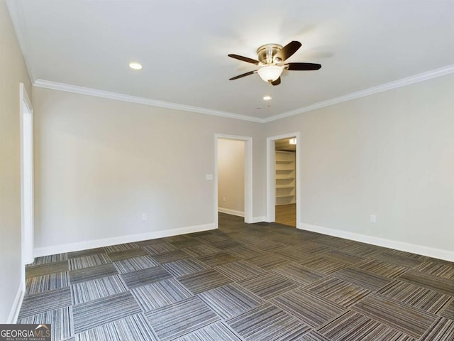 unfurnished room featuring ceiling fan, ornamental molding, and dark carpet