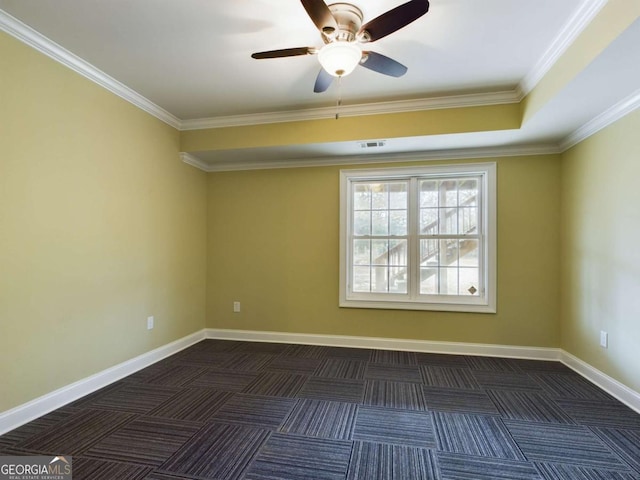 unfurnished room featuring ceiling fan, dark carpet, and ornamental molding