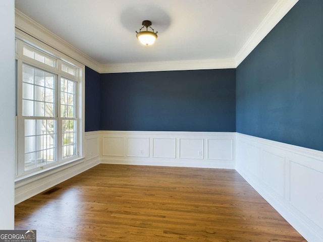 spare room with dark hardwood / wood-style floors and crown molding