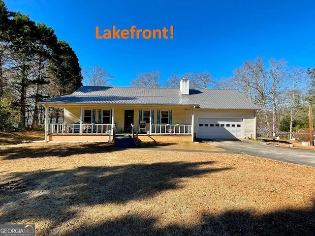 view of front of home featuring a porch and a garage