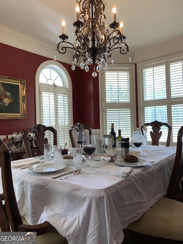 dining area with a chandelier and ornamental molding