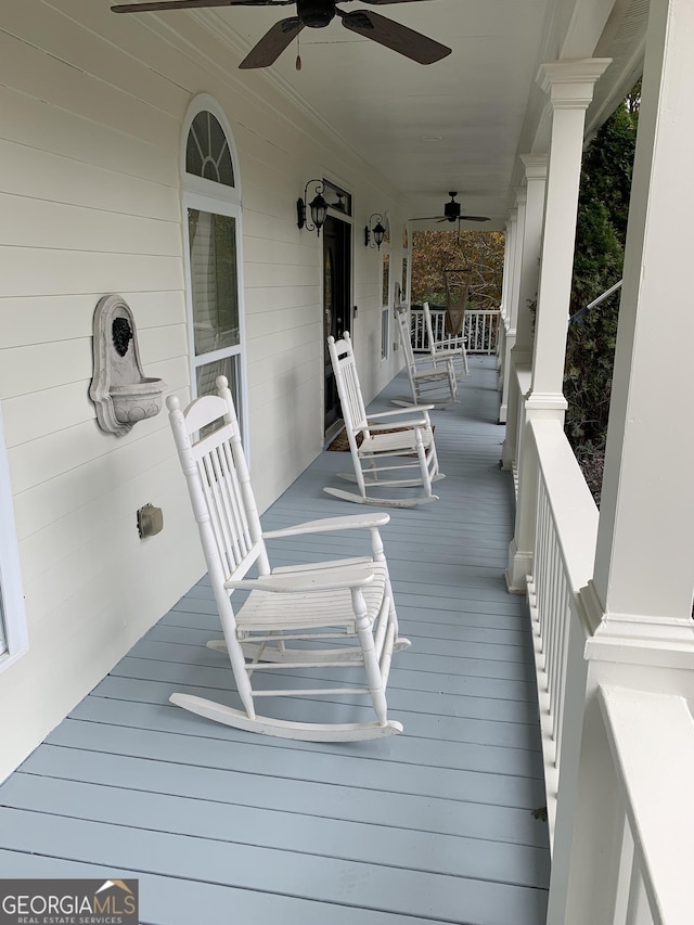 wooden terrace with ceiling fan and a porch