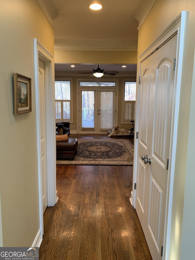 hall with dark hardwood / wood-style flooring, ornamental molding, and french doors