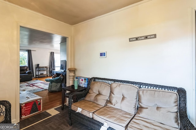 living room featuring dark hardwood / wood-style flooring and crown molding