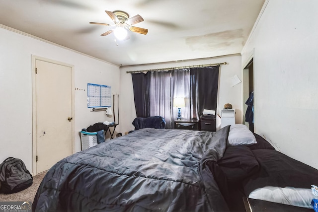 bedroom with ceiling fan, ornamental molding, and carpet floors