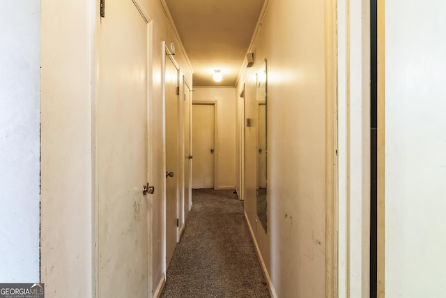 corridor featuring dark carpet