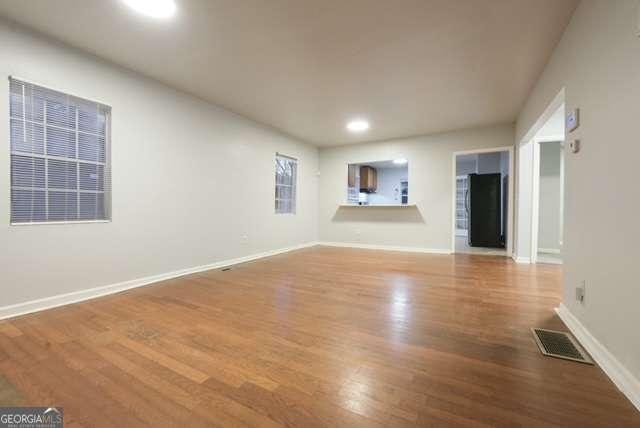 unfurnished living room with hardwood / wood-style floors