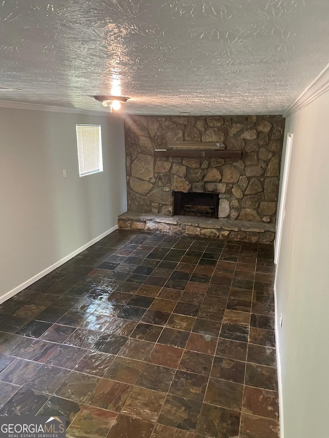 unfurnished living room featuring a textured ceiling, crown molding, and a stone fireplace