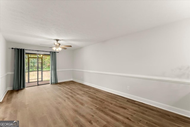 unfurnished room featuring ceiling fan and hardwood / wood-style flooring