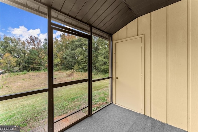 unfurnished sunroom featuring vaulted ceiling and a healthy amount of sunlight