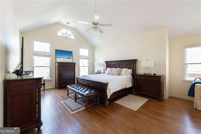 bedroom with ceiling fan, multiple windows, dark hardwood / wood-style flooring, and lofted ceiling