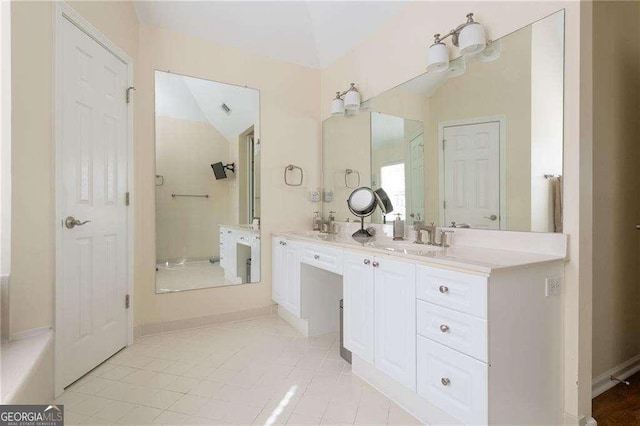 bathroom featuring vanity, vaulted ceiling, and tile patterned floors