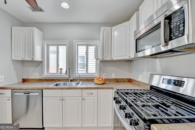 kitchen featuring sink, white cabinetry, and stainless steel appliances