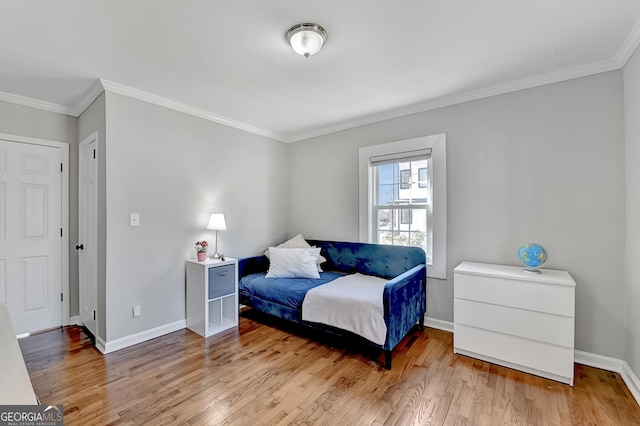 bedroom with light hardwood / wood-style floors and ornamental molding