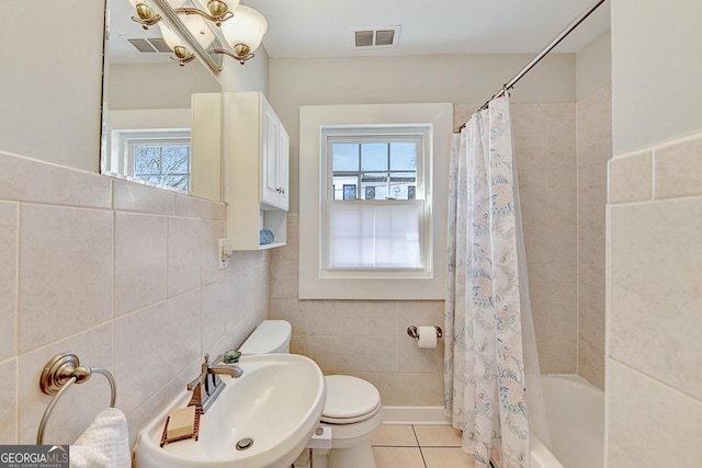 full bathroom featuring shower / tub combo, tile patterned flooring, tile walls, sink, and toilet