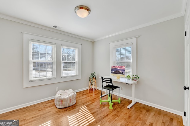 office space with hardwood / wood-style floors and crown molding