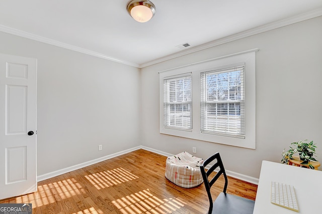 sitting room with hardwood / wood-style flooring and crown molding