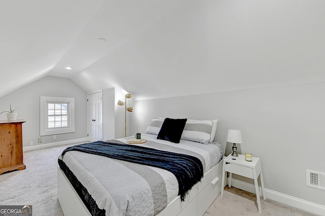 bedroom featuring light carpet and lofted ceiling