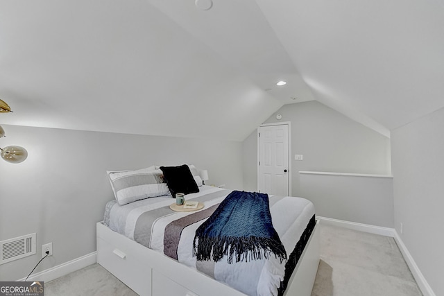 bedroom with light carpet and vaulted ceiling