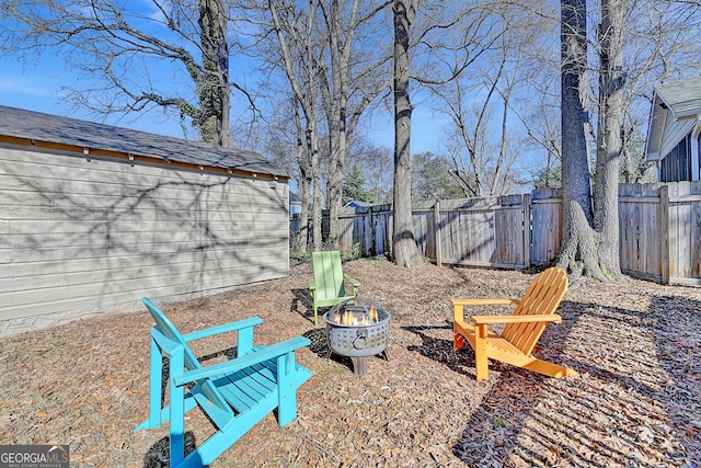 view of yard with a fire pit