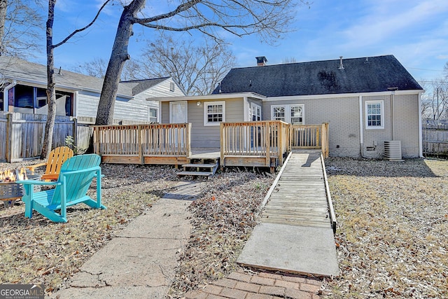 rear view of property with a wooden deck and central AC