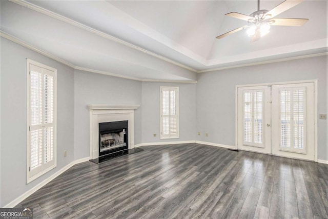 unfurnished living room featuring ceiling fan, dark hardwood / wood-style flooring, french doors, and a healthy amount of sunlight