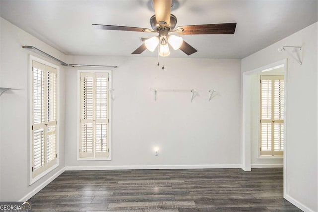 spare room featuring ceiling fan and dark hardwood / wood-style flooring