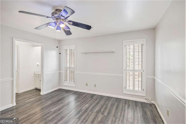 spare room with ceiling fan and dark wood-type flooring