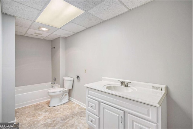 full bathroom with toilet, tub / shower combination, a drop ceiling, and vanity