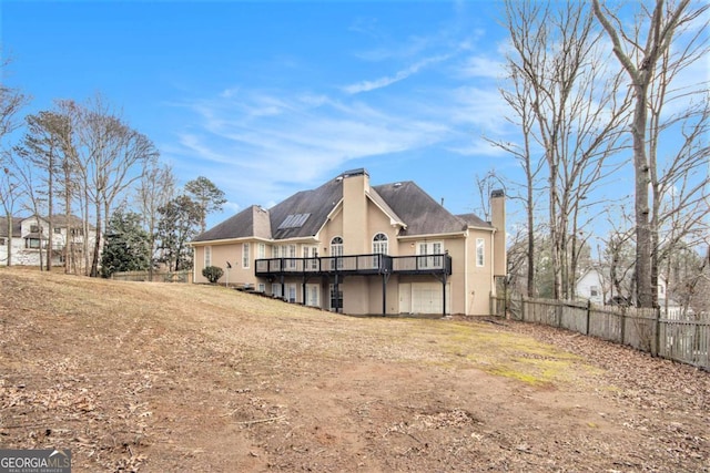 rear view of property with a wooden deck