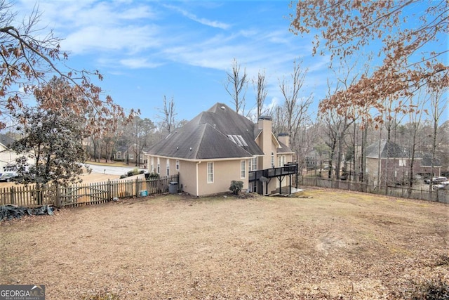 rear view of property with a yard