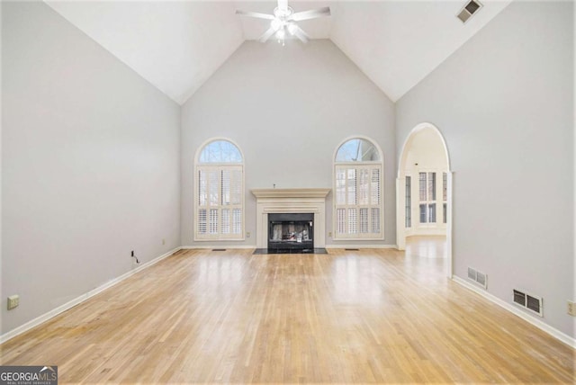 unfurnished living room featuring ceiling fan, light hardwood / wood-style flooring, and high vaulted ceiling