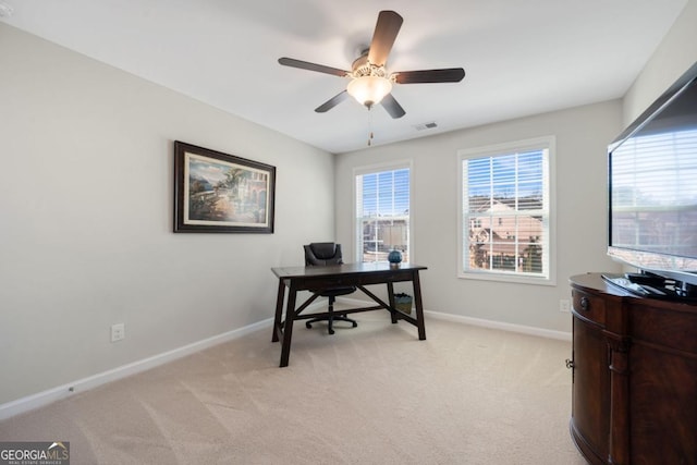 office space featuring ceiling fan and light colored carpet