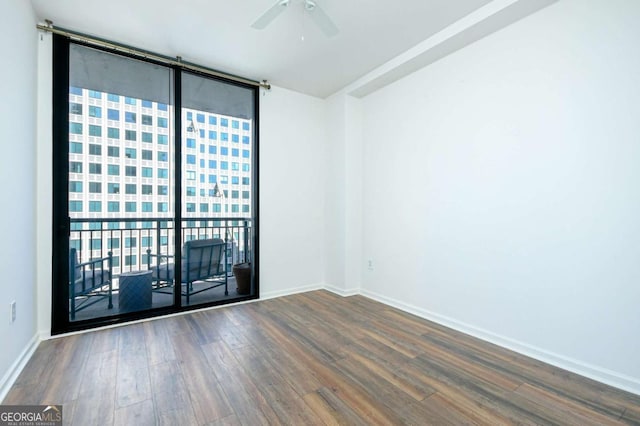 spare room with ceiling fan, a wealth of natural light, and hardwood / wood-style floors