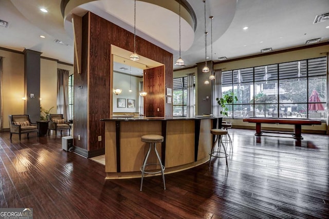 bar with decorative light fixtures, dark hardwood / wood-style floors, pool table, and ornamental molding