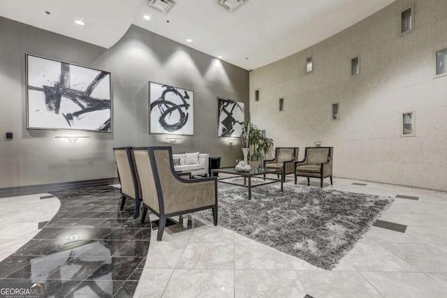 living room with a towering ceiling