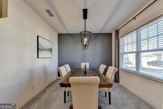 dining space with light colored carpet