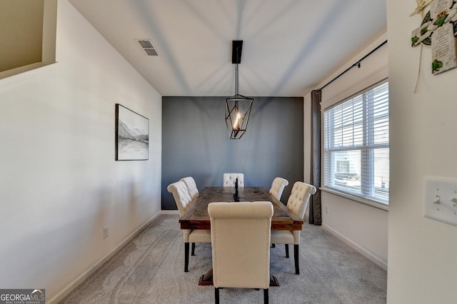 dining area featuring light colored carpet