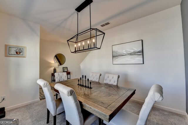 dining space featuring light carpet