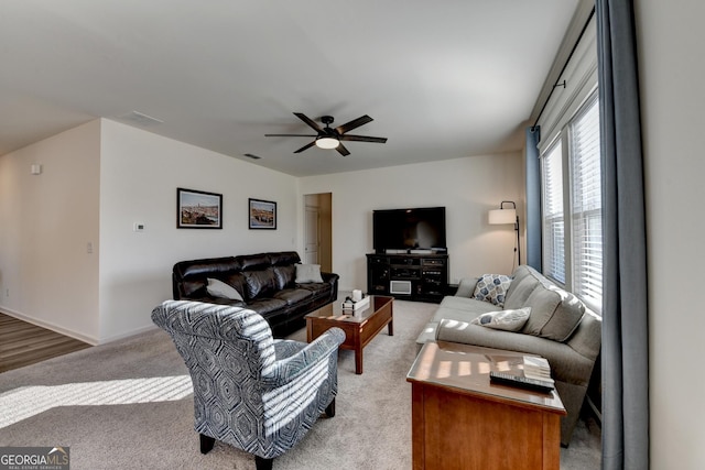 carpeted living room featuring ceiling fan