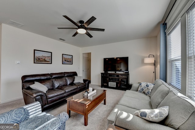 living room featuring light carpet and ceiling fan