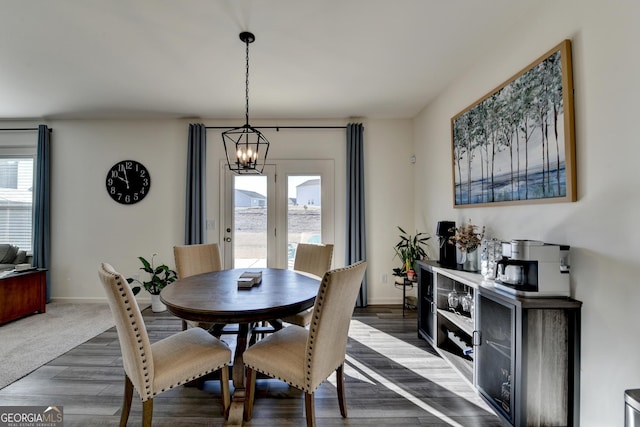 dining room featuring dark hardwood / wood-style flooring and a chandelier