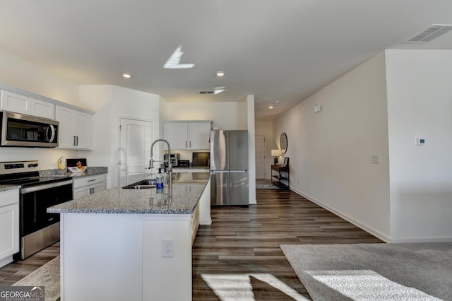 kitchen featuring a kitchen island with sink, sink, white cabinets, and appliances with stainless steel finishes