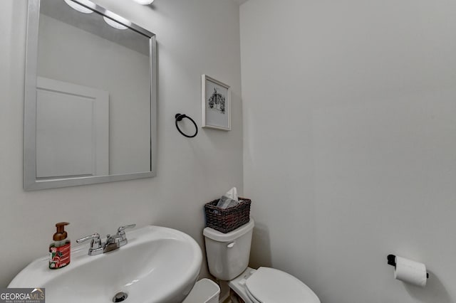 bathroom featuring sink and toilet