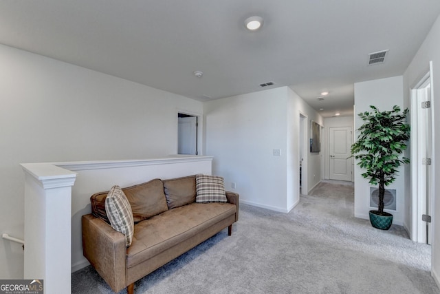 sitting room featuring light carpet