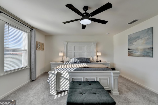 bedroom with light colored carpet and ceiling fan