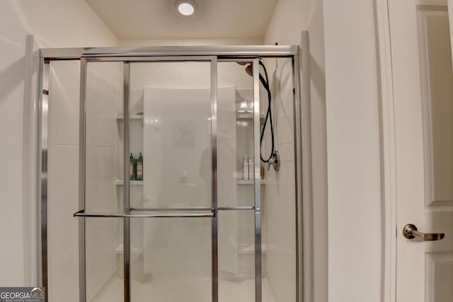 bathroom with a shower with door