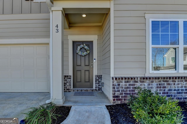 doorway to property with a garage