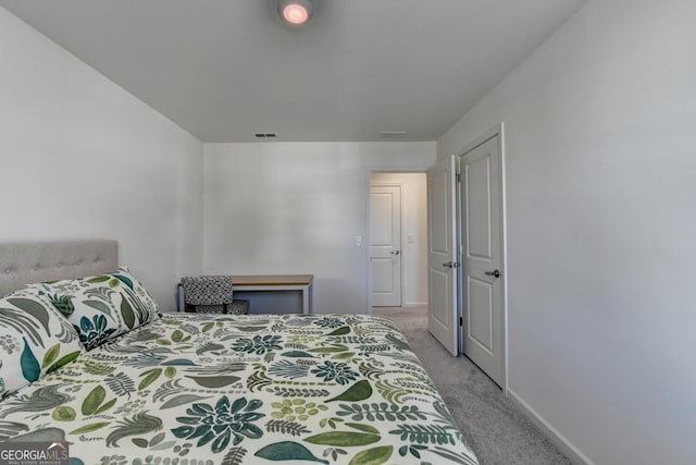 bedroom featuring light carpet