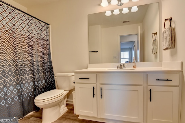 bathroom with vanity, hardwood / wood-style flooring, and toilet